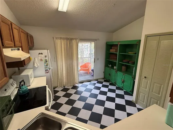 a kitchen with a refrigerator a stove a washer and dryer