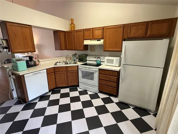 a kitchen with a sink stove and refrigerator