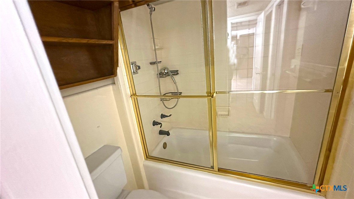 1500 Halbert Street Killeen, TX 76541 - Photo 22 of 36 a bathroom with a glass door shower and tub