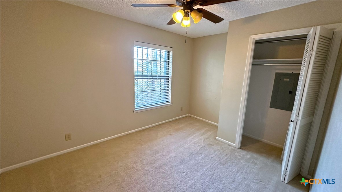 1500 Halbert Street Killeen, TX 76541 - Photo 23 of 36 an empty room with windows and chandelier fan