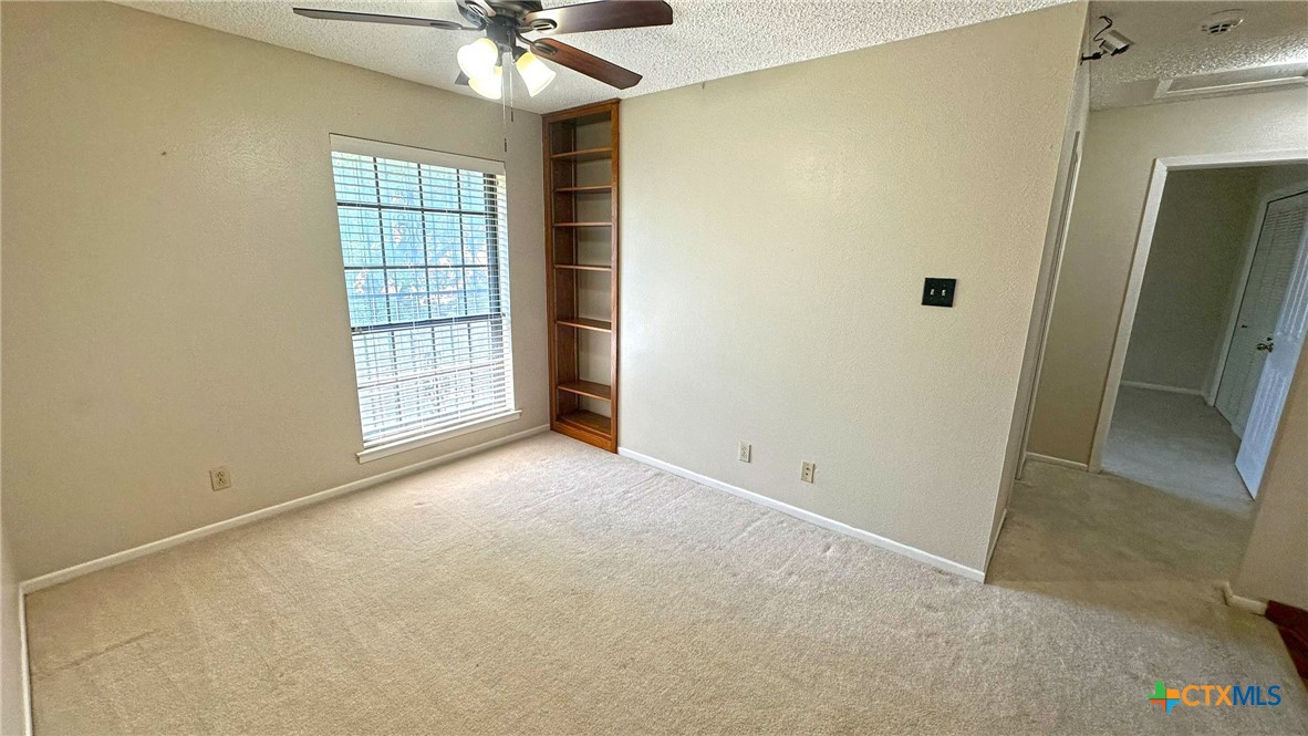 1500 Halbert Street Killeen, TX 76541 - Photo 31 of 36 an empty room with windows and ceiling fan