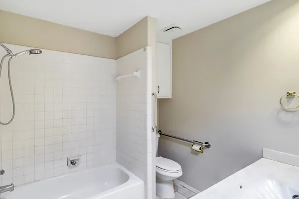 a bathroom with a shower a toilet and sink