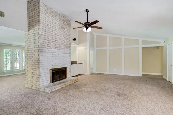 a view of empty room with fireplace