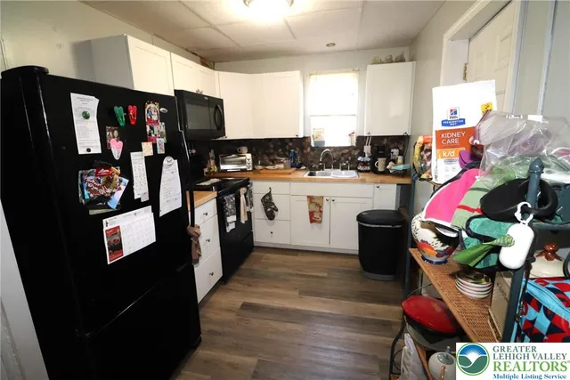 a kitchen with stainless steel appliances granite countertop a refrigerator a stove a sink and dishwasher