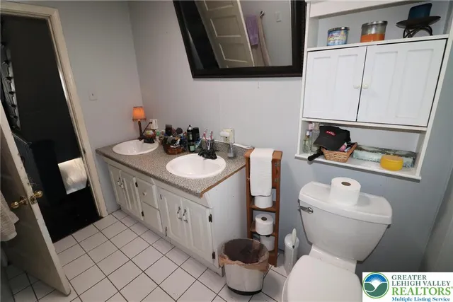 a bathroom with a toilet sink and mirror
