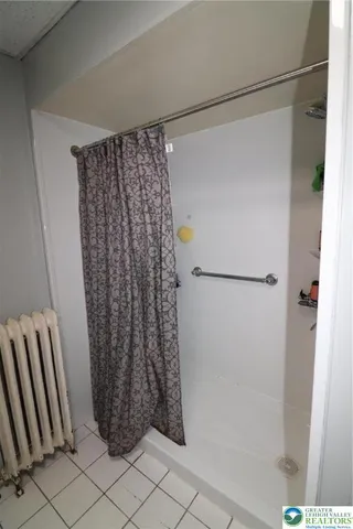 a bathroom with a shower and a tub