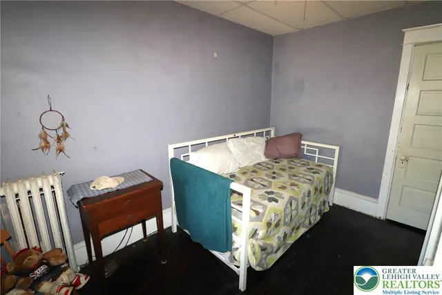 a bed sitting in a bedroom next to a window