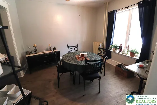 a view of a dining room with furniture and a window