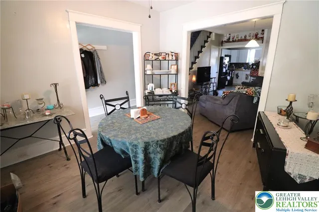 a view of a dining room with furniture and wooden floor