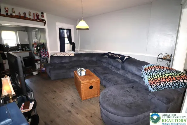 a living room with furniture and a mirror