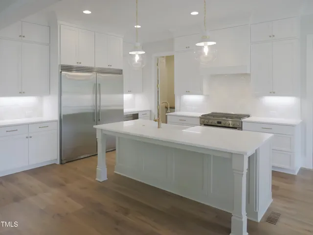 a kitchen with granite countertop a stove and a sink