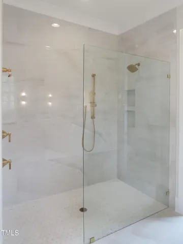 a view of a room with a white wall and a window