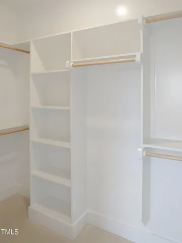 an empty room with fireplace and wooden floor