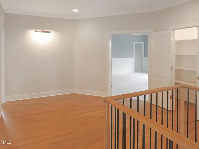 a view of an empty room with a fireplace and a window