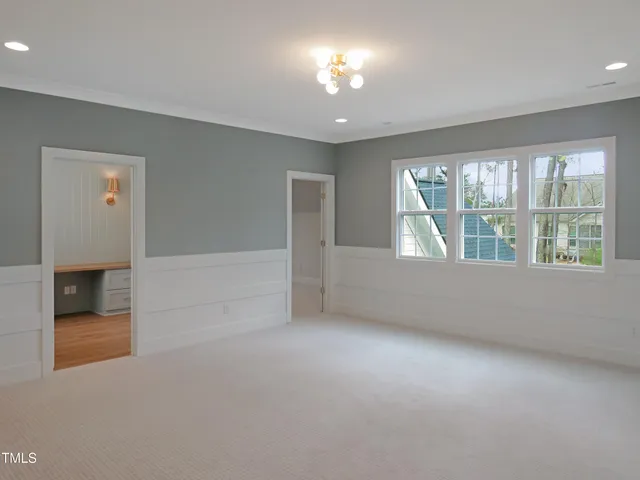 a view of an empty room with fire place and a fireplace