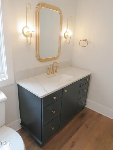 a bathroom with a sink vanity and a mirror