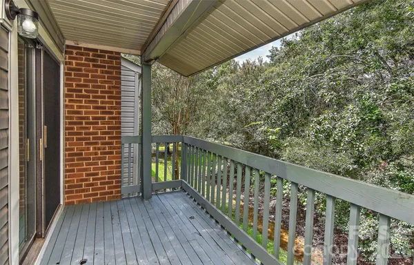a view of balcony with wooden floor