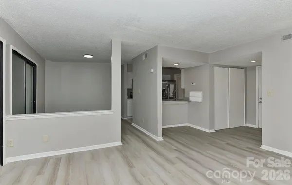 a view of hallway with wooden floor