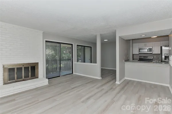 a view of a kitchen with a sink and a stove top oven
