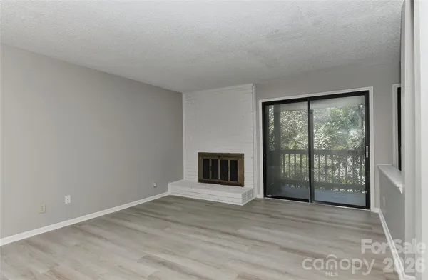 a view of a room with wooden floor and a window
