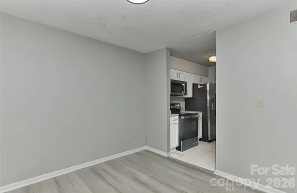 a view of a kitchen with a sink and refrigerator