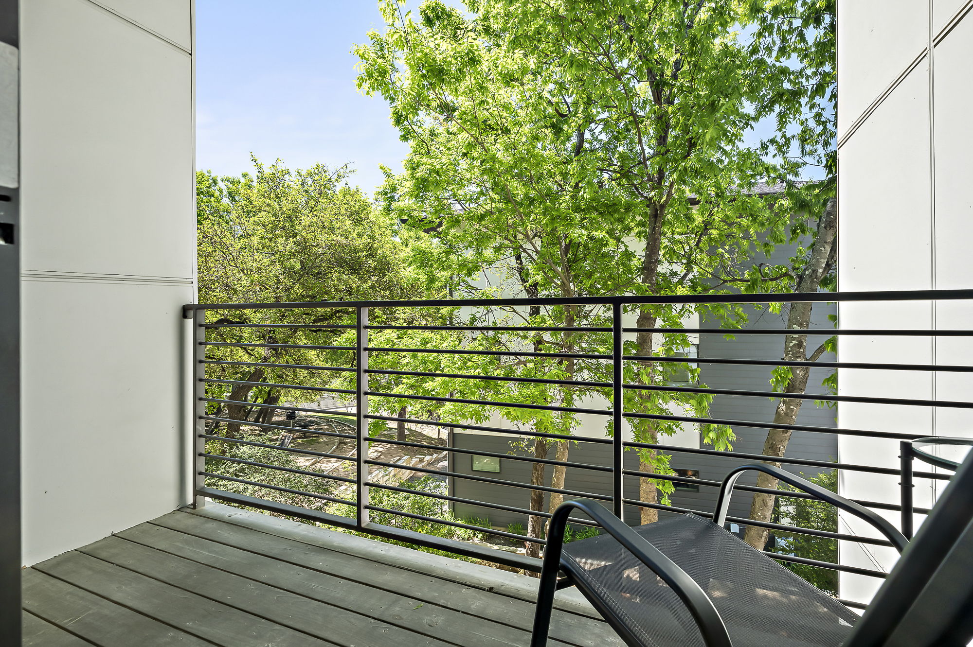 3700 Clawson Road, Unit 501 Austin, TX 78704 - Photo 14 of 40 Balcony off of living room overlooks green, leafy area