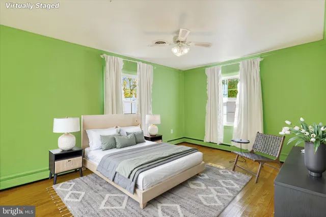 a spacious bedroom with a bed and a chandelier