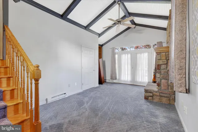 a view of an empty room and fire place