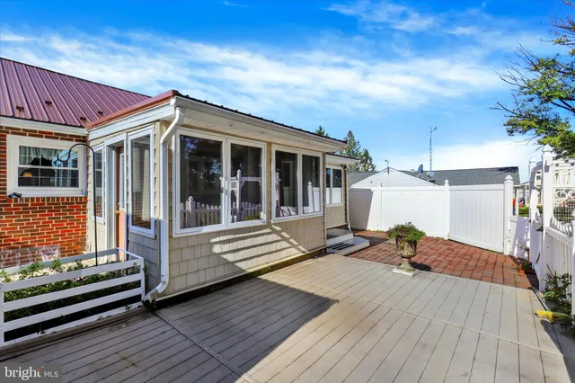 a view of backyard with a deck and wooden floor