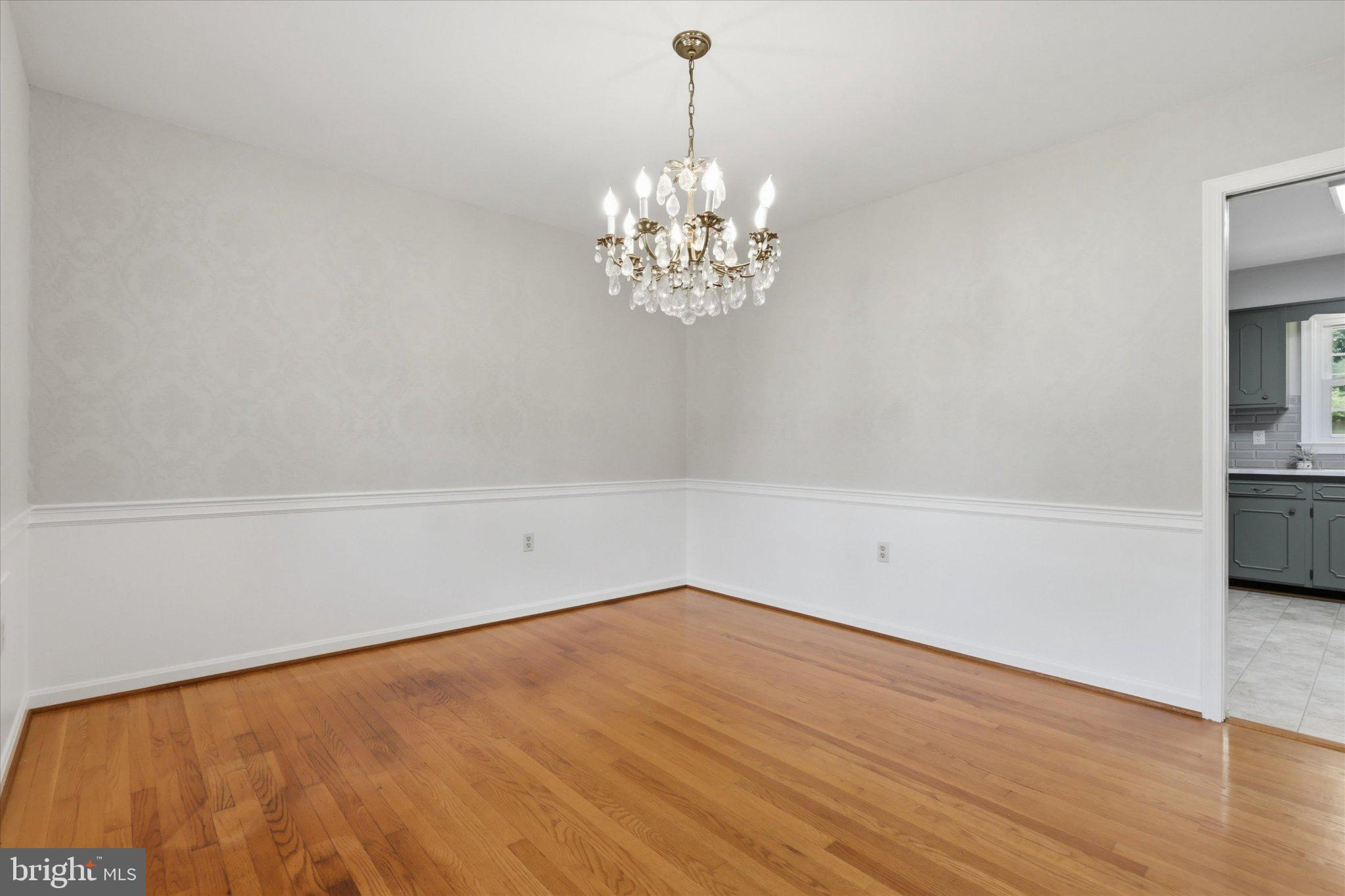 7007 Runnymeade Court Frederick, MD 21702 - Photo 7 of 37 Elegant space with a sparkling chandelier.