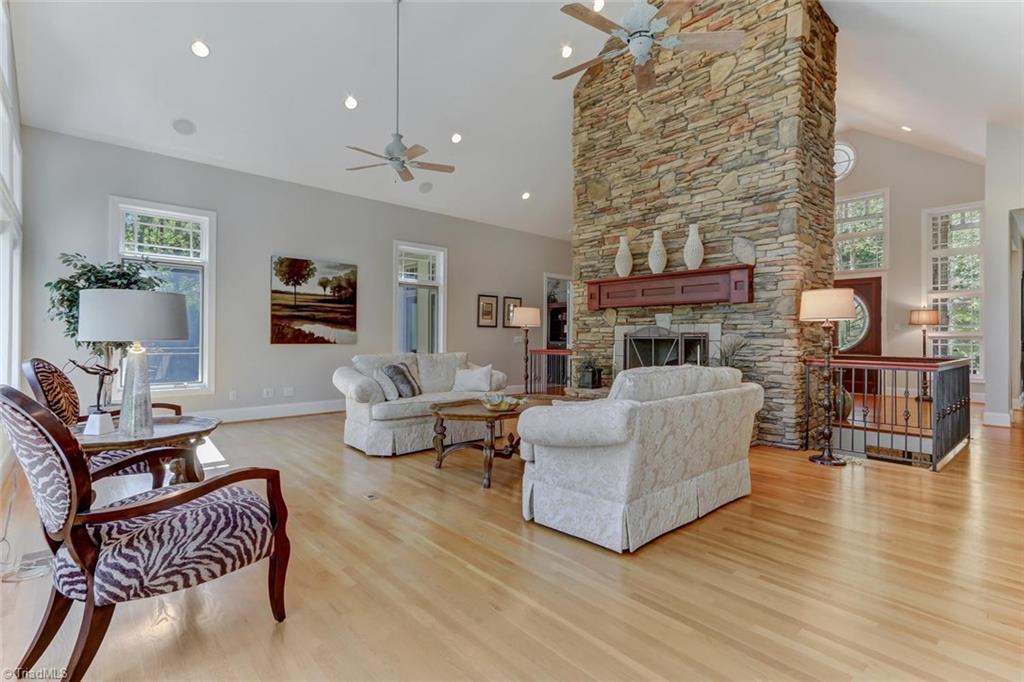 5260 Bunch Road Summerfield, NC 27358 - Photo 10 of 30 The Great Room features this stunning stone clad gas burning fireplace with raised hearth and wood mantel. Not shown are built-in lighted art niches on each side of the fireplace. Recessed ceiling lights, built-in speakers, two dropped ceiling fans, and of course the beautiful hardwood floors continue.