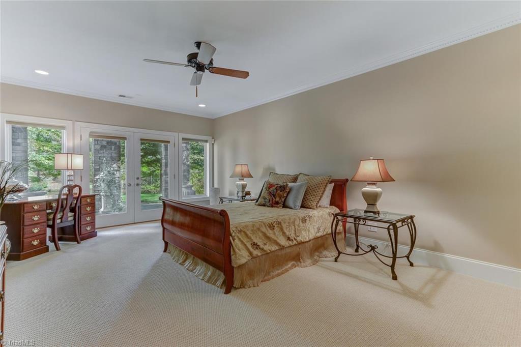 5260 Bunch Road Summerfield, NC 27358 - Photo 18 of 30 Bedroom 4 on the lower level has wall to wall Berber carpeting, French Doors to patio, recessed ceiling lights, and fan. Direct access to shared bath.