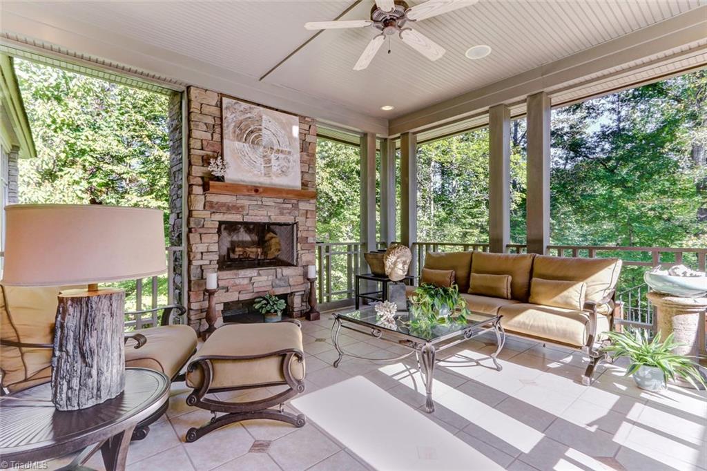 5260 Bunch Road Summerfield, NC 27358 - Photo 2 of 30 The screened porch features tile flooring, maintenance free bead-board ceiling, ceiling fan, recessed lighting, outdoor speakers, and wood burning fireplace. A comfortable place to take in the views.