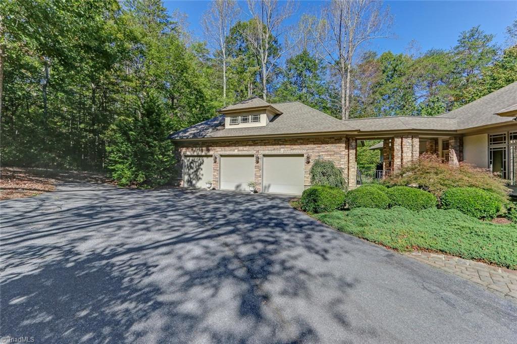 5260 Bunch Road Summerfield, NC 27358 - Photo 27 of 30 The over-sized three car garage with attached breezeway to house. Stairs to second level unfinished floored attic space. Has been plumbed for a bathroom. Charming stone path from breezeway to side of house.
