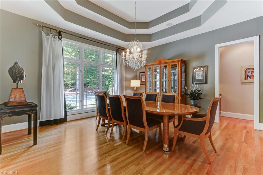 5260 Bunch Road Summerfield, NC 27358 - Photo 6 of 30 The Dining Room. Wood flooring, double tray ceiling, central chandelier, and ceiling speakers.