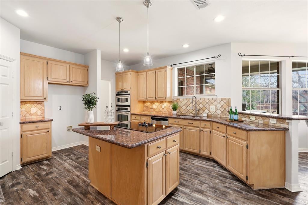 1904 Strait Lane Flower Mound, TX 75028 - Photo 14 of 33 a kitchen with stainless steel appliances granite countertop a sink stove and refrigerator