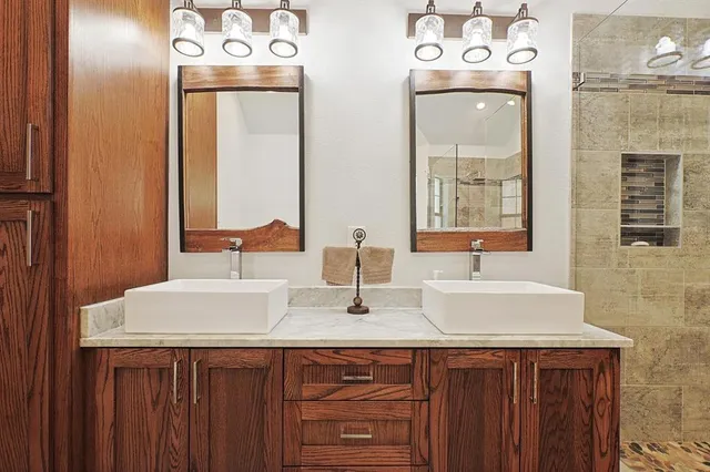 a bathroom with a sink vanity and a mirror