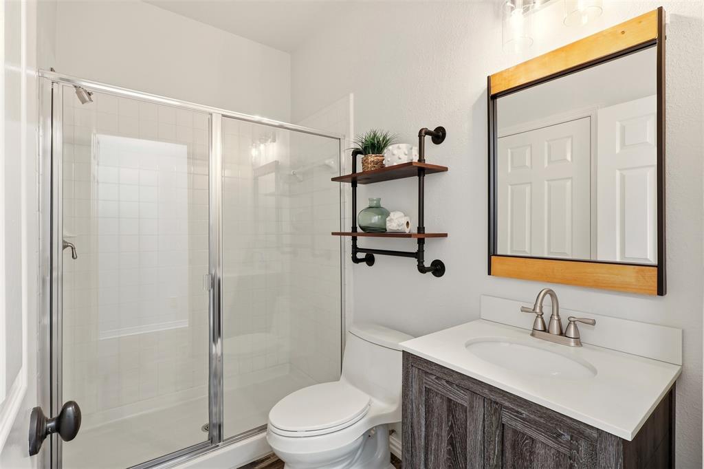 1904 Strait Lane Flower Mound, TX 75028 - Photo 15 of 33 a bathroom with a sink toilet vanity and shower