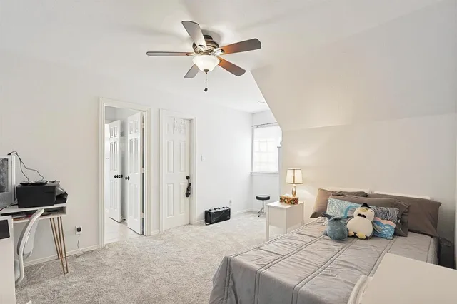 a bedroom with a bed and a ceiling fan