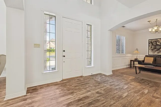 a view of a livingroom with a window and wooden floor