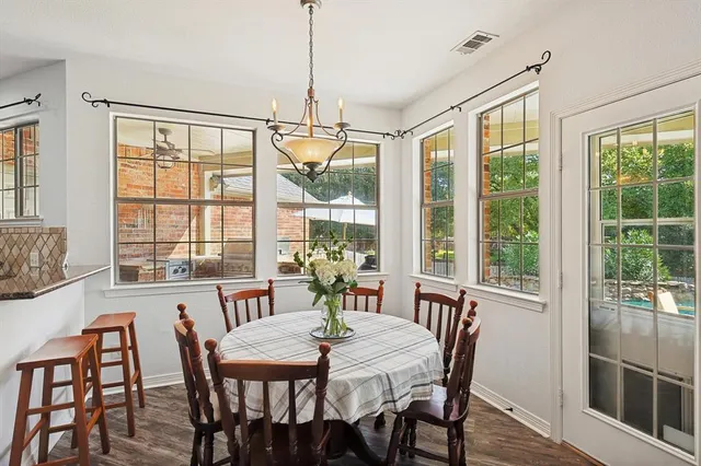 a view of a dining room with furniture large windows and wooden floor