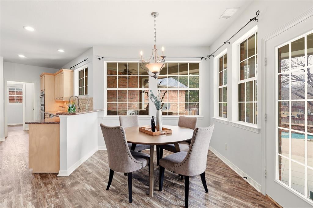 1904 Strait Lane Flower Mound, TX 75028 - Photo 10 of 33 a dining room with furniture a chandelier and wooden floor