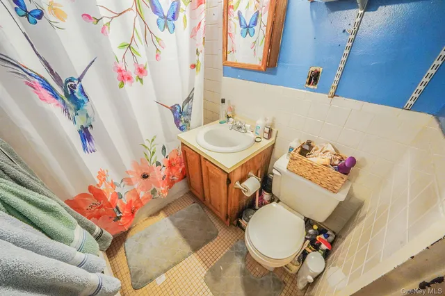 a bathroom with a sink toilet and mirror