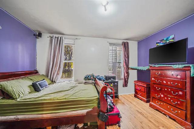 a bedroom with furniture and a flat screen tv