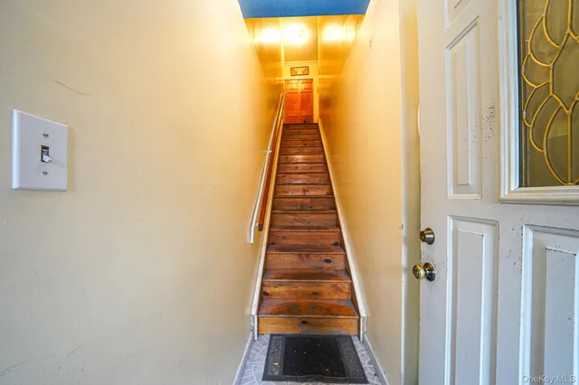 a view of a hallway with wooden floor and door