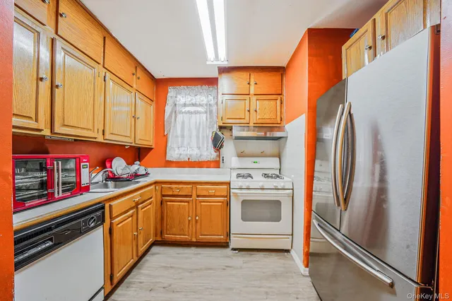 a kitchen with stainless steel appliances granite countertop a refrigerator and a sink