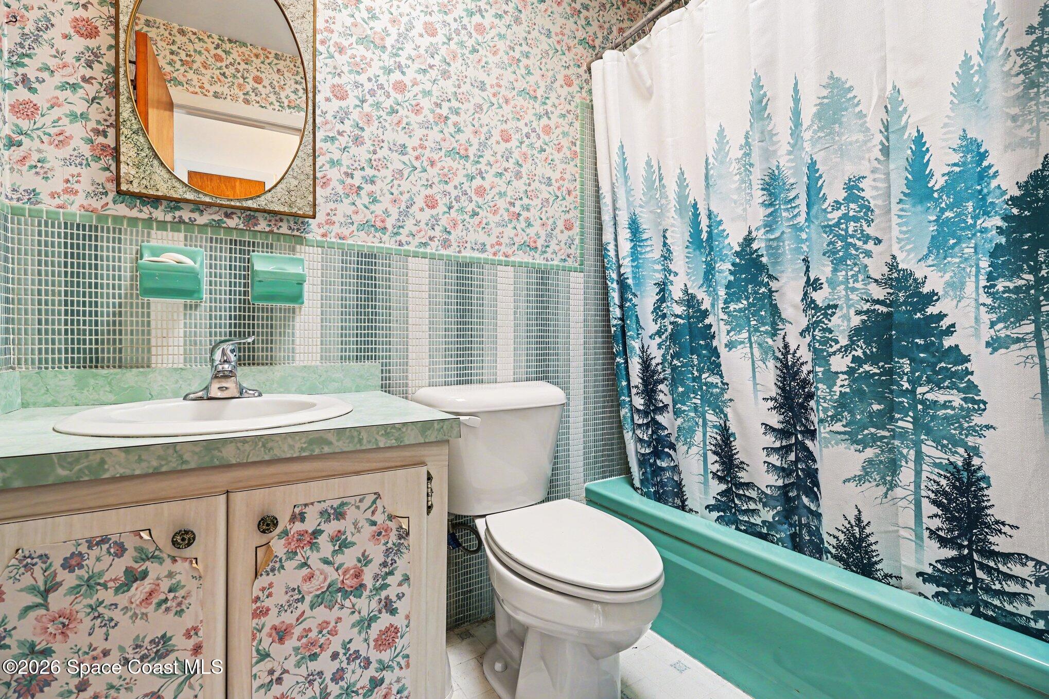979 Kings Post Road Rockledge, FL 32955 - Photo 12 of 15 a bathroom with a granite countertop toilet sink and mirror