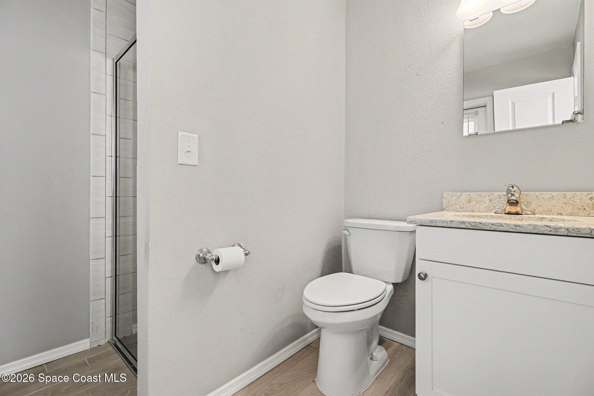 979 Kings Post Road Rockledge, FL 32955 - Photo 13 of 15 a bathroom with a toilet and a sink