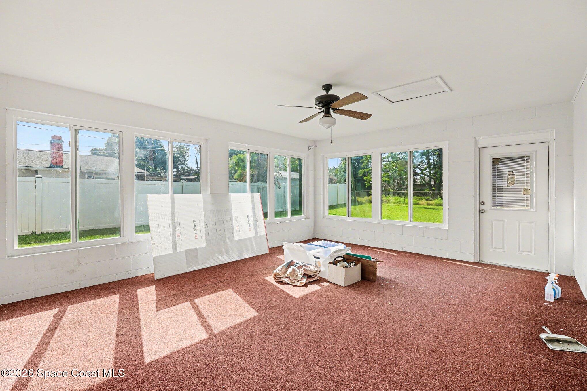 979 Kings Post Road Rockledge, FL 32955 - Photo 14 of 15 a living room with furniture and a large window