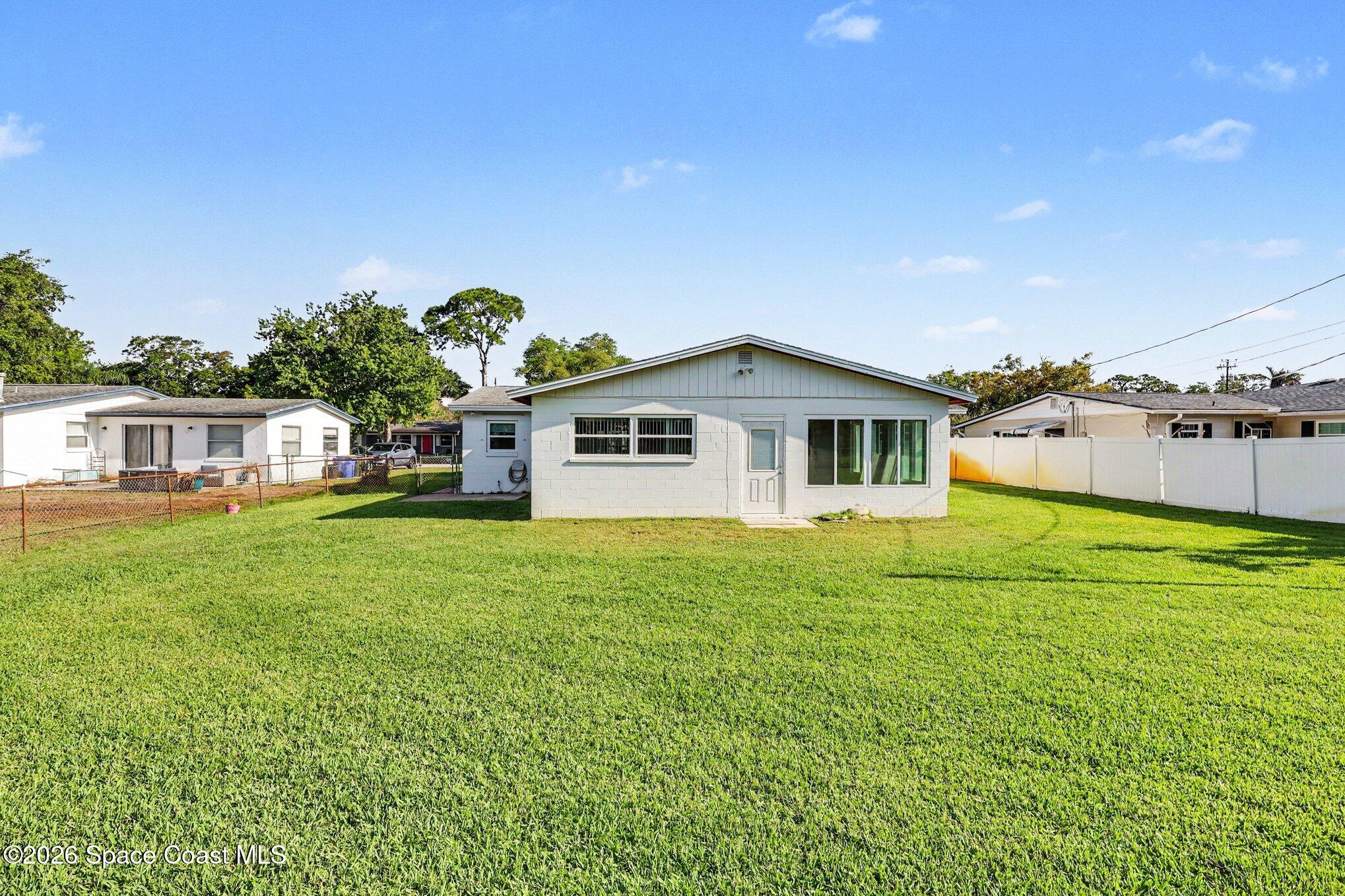 979 Kings Post Road Rockledge, FL 32955 - Photo 15 of 15 a front view of a house with a garden